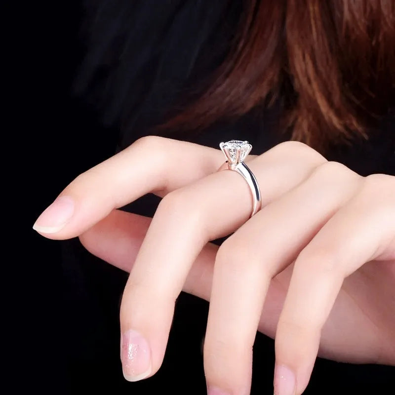 White gold plated geometric ring with six-claw setting holding a zircon stone.