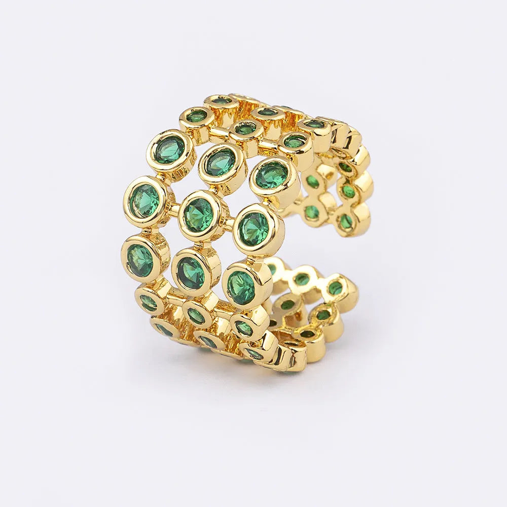 Gold-coloured wide copper ring with a large green zircon stone in a three-layer setting.