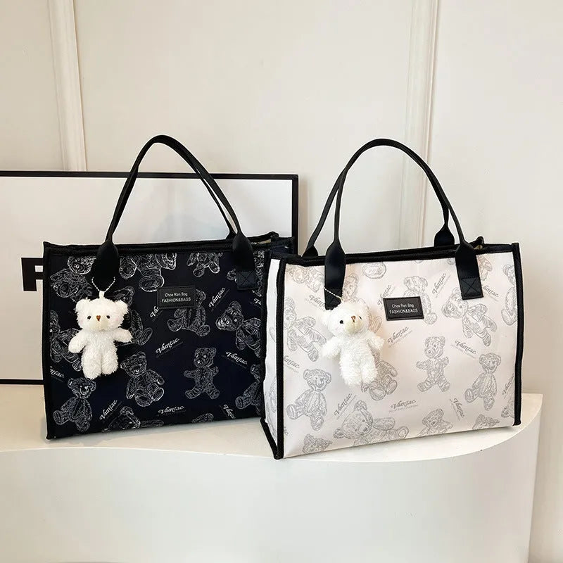 Women's black canvas tote bag with rhombus pattern and shoulder strap