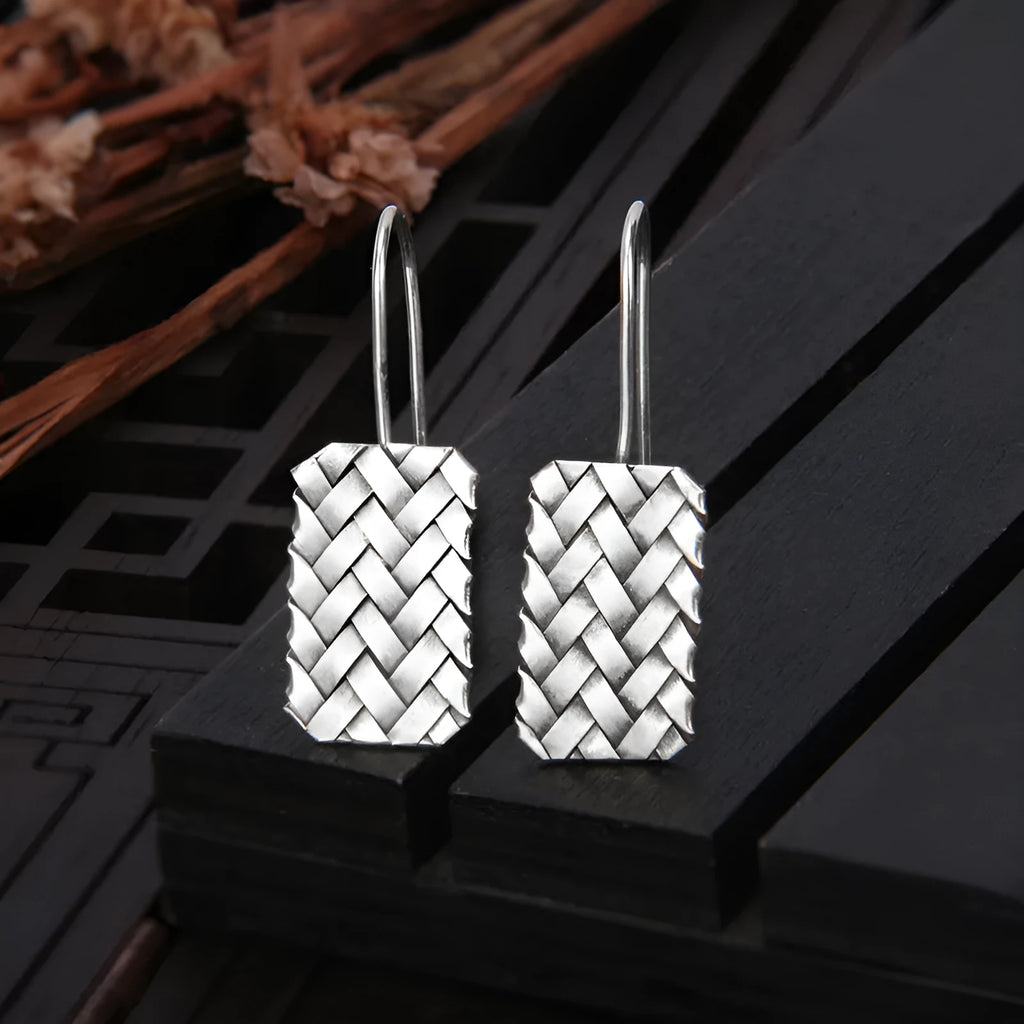 Sterling silver rectangular drop earrings with a woven diamond plaid geometric pattern.