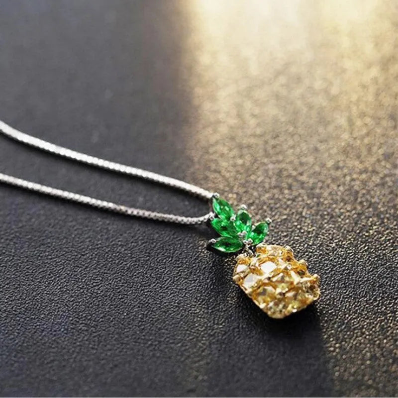 Silver pineapple charm necklace with geometric diamond pattern on adjustable chain