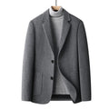 Men's slim fit wool blazer in a classic colour on a hanger, showing notch lapel and button front.