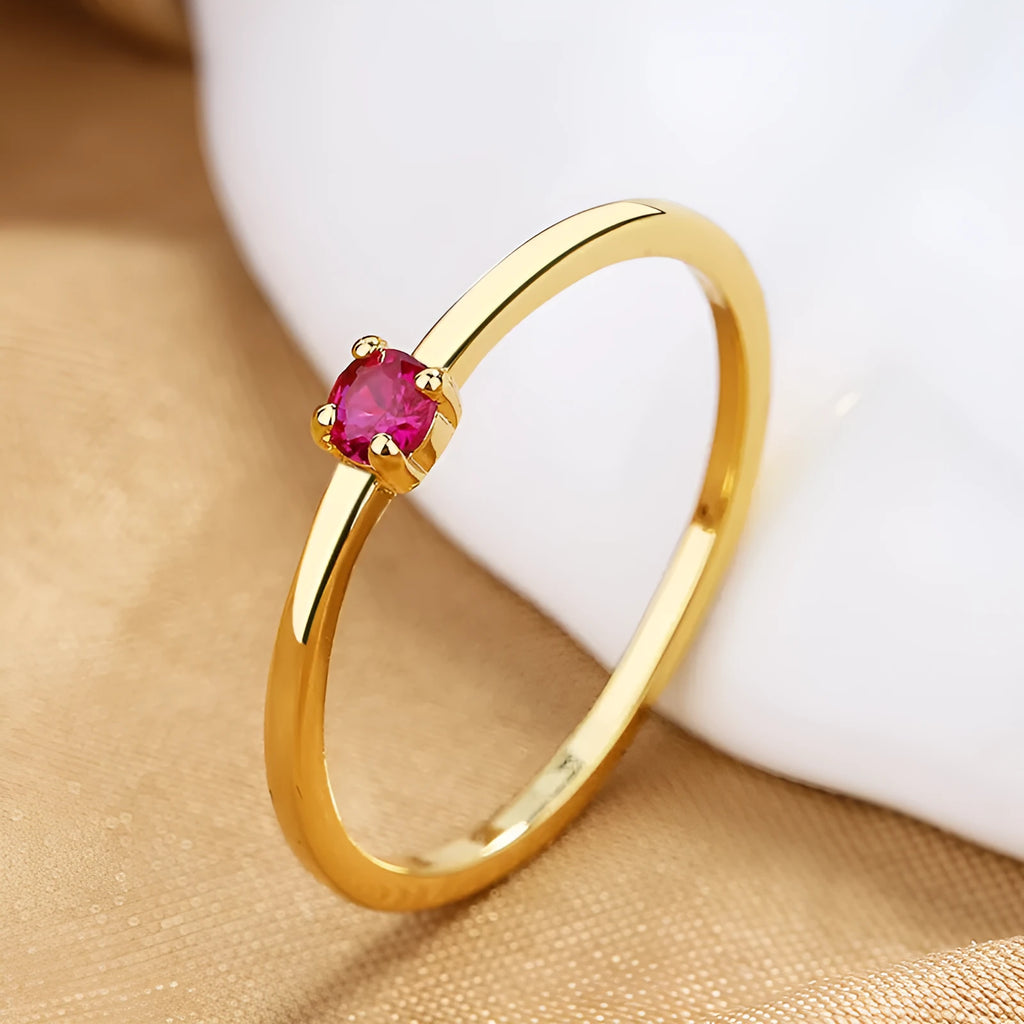 A simple copper ring for women with a single diamond on a fine circle band, shown in blue, green, red, or white.