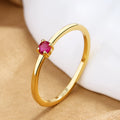 A simple copper ring for women with a single diamond on a fine circle band, shown in blue, green, red, or white.