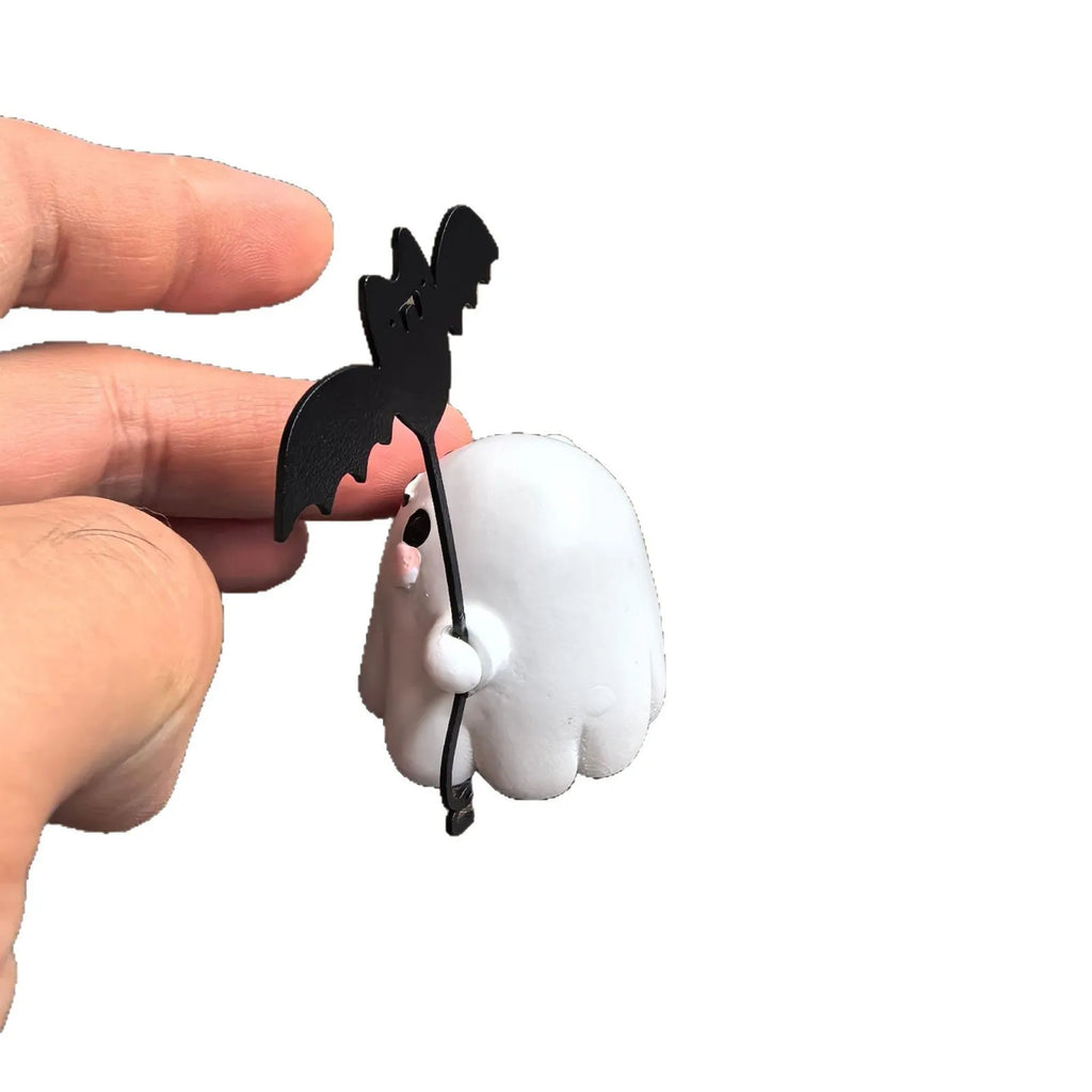 Mini resin statue of a ghost walking a dog and holding a bat, a Halloween ornament.