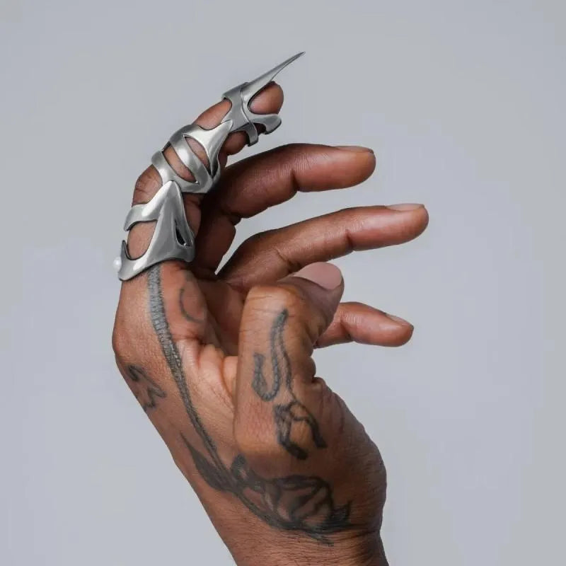 Silver alloy punk armour finger stall covering a knuckle.