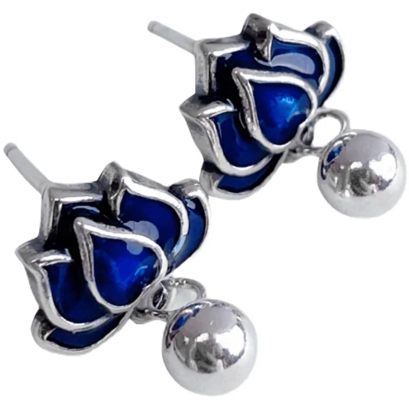 A pair of alloy lotus ear studs with retro seedpod tassel design, shown in lotus colour.