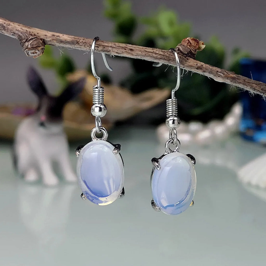 Moonlight white opal drop earrings with cross-shaped retro design and electroplated alloy finish