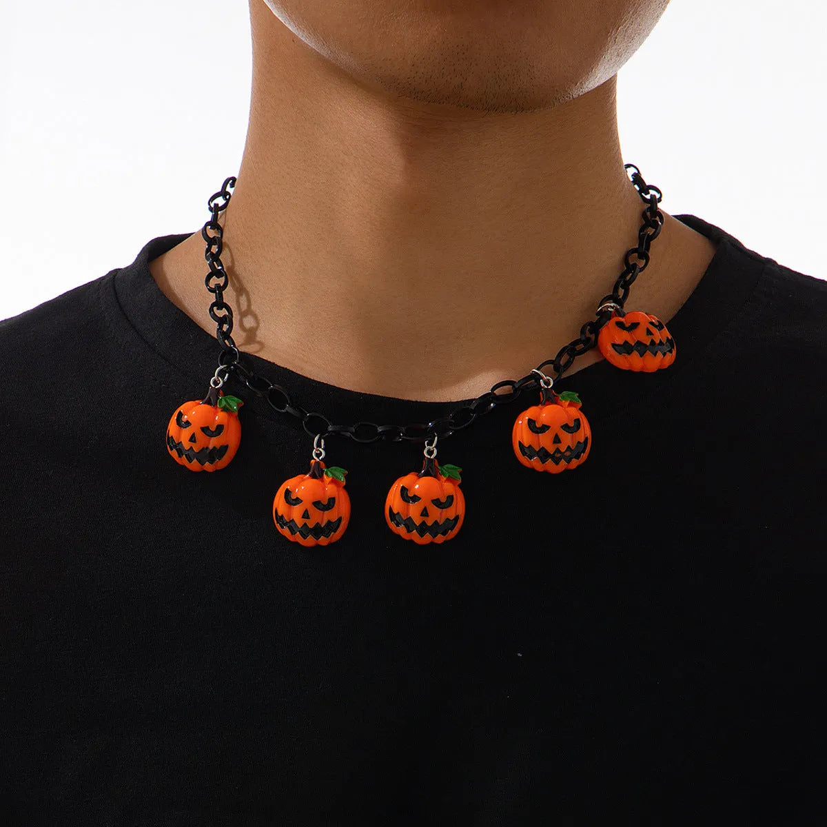 Colourful Halloween necklace showing a cartoon ghost pumpkin pendant on a chain.
