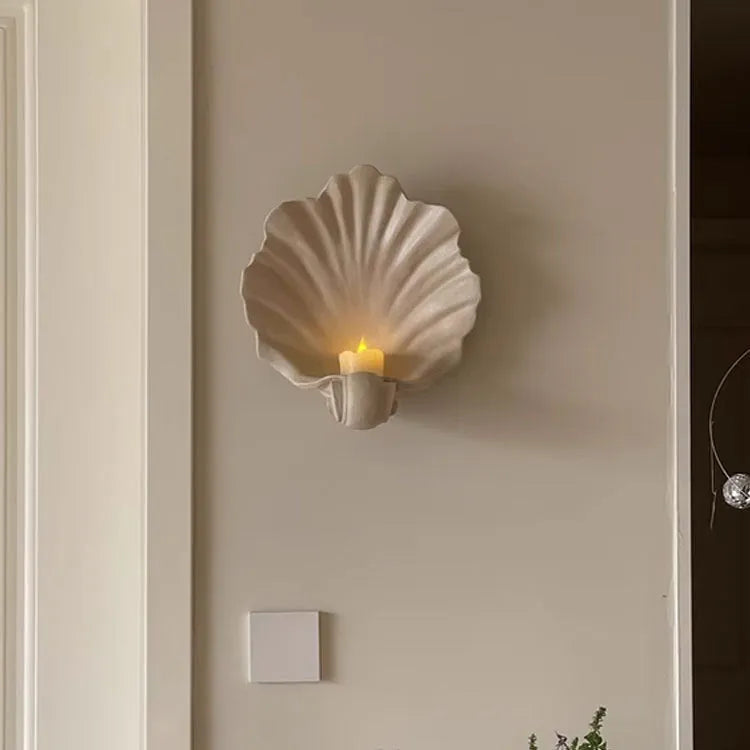 White resin shell-shaped fruit plate ornament with light luxury styling on a table.