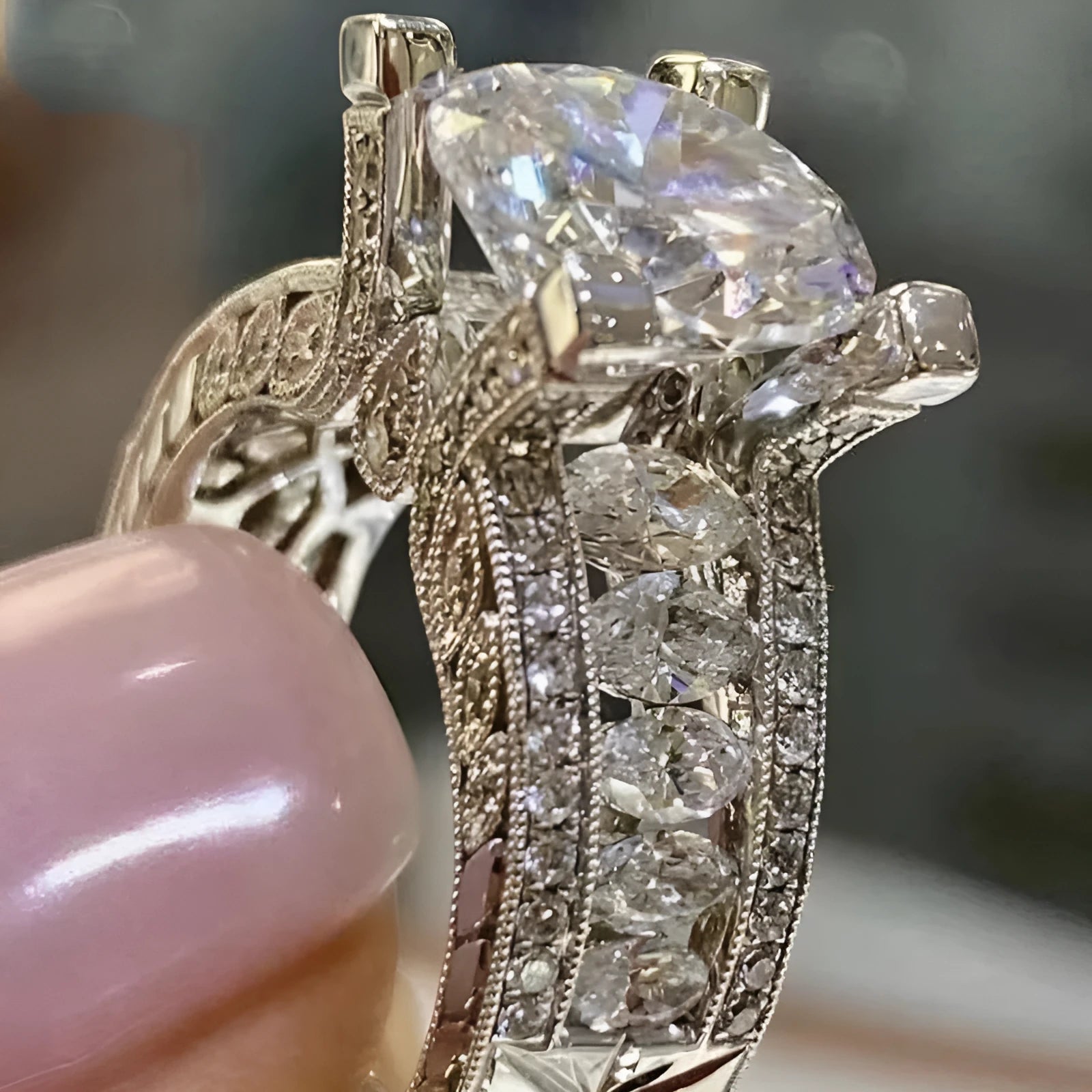 Geometric silver-coloured women's ring with round design elements on a finger, shown in gold and white colour options.