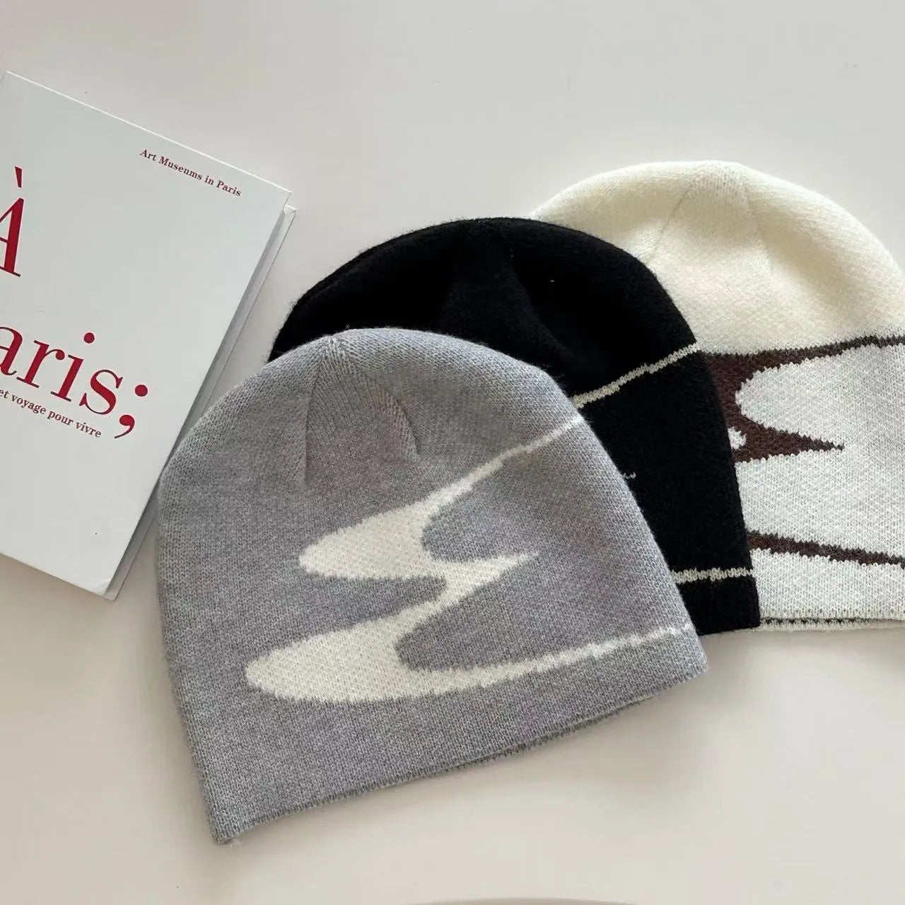 Knitted acrylic beanie hat in black, grey, or white for autumn and winter wear