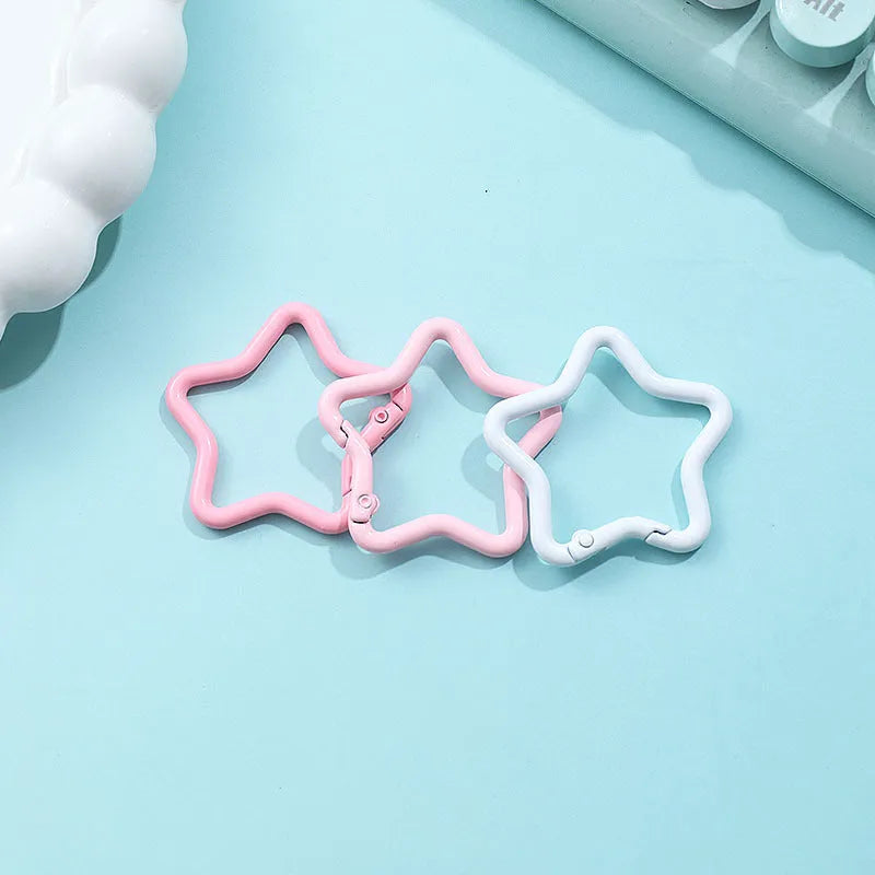 Zinc alloy five-pointed star keychain in multiple macaron colours including pink, blue, and purple