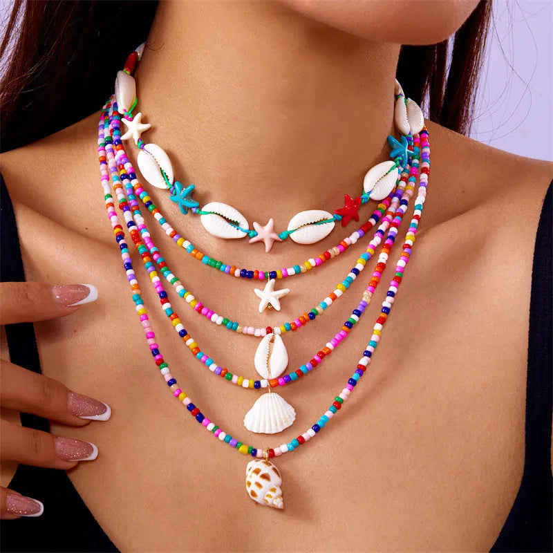 Five multi-layer women's necklaces with starfish shell conch bead designs in blue and mixed colours