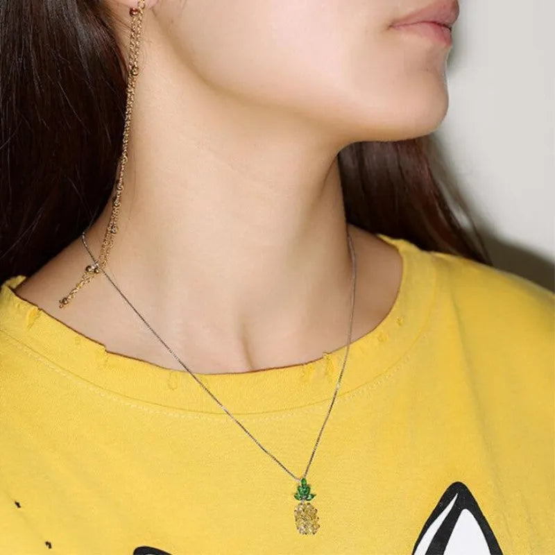 Silver pineapple charm necklace with geometric diamond pattern on adjustable chain