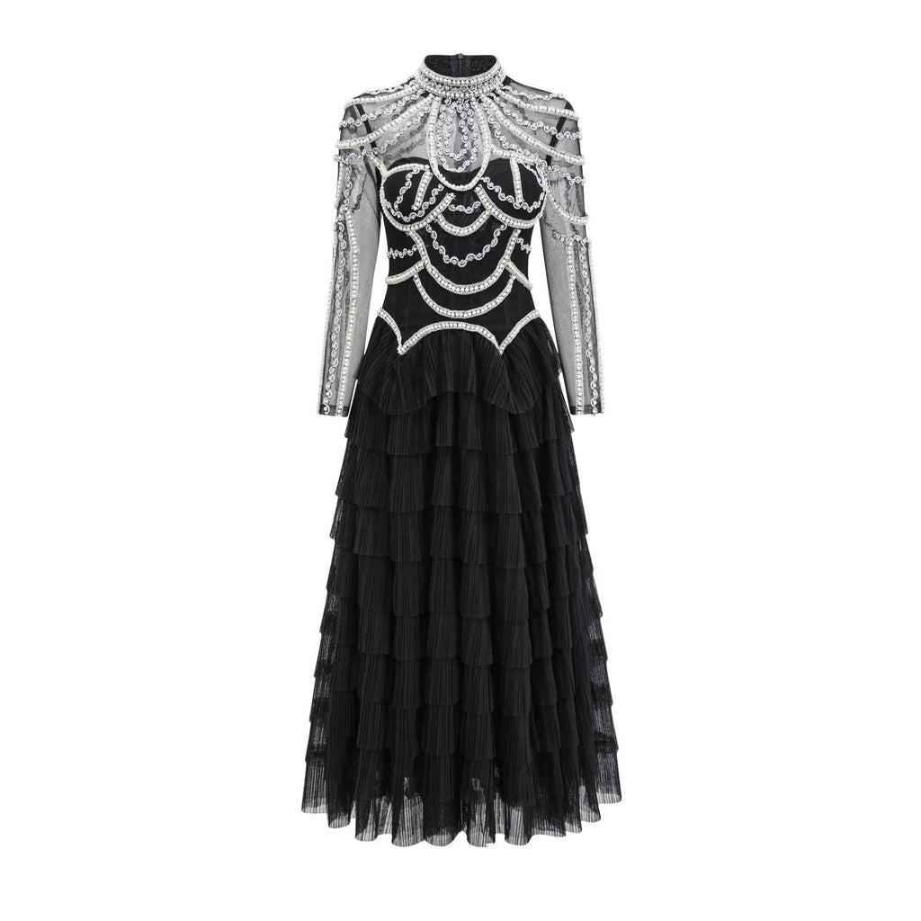 Women's long sleeve black dress with beaded decoration and a full-length skirt.