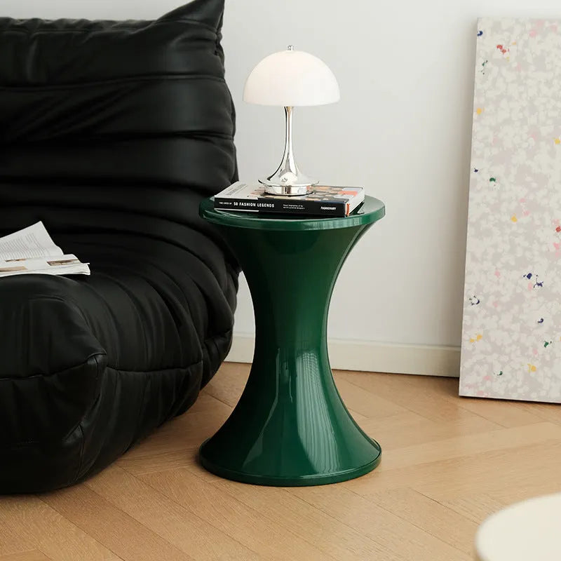 Plastic hourglass shoe changing stool in green colour showing contoured seating design