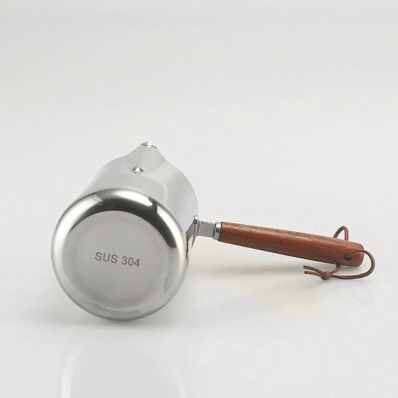 Stainless steel garland coffee cup with a scaled wooden handle shown in a simple solid colour.