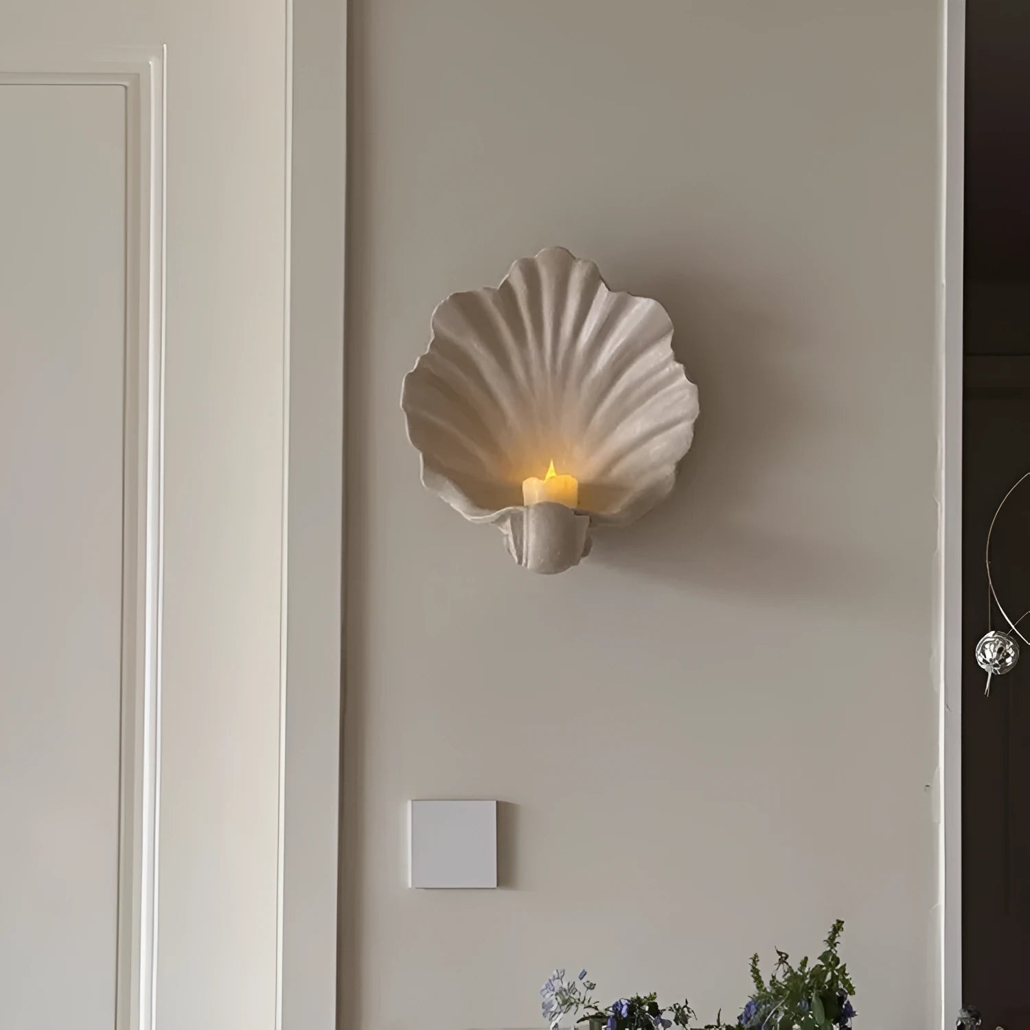 White resin shell-shaped fruit plate ornament with light luxury styling on a table.