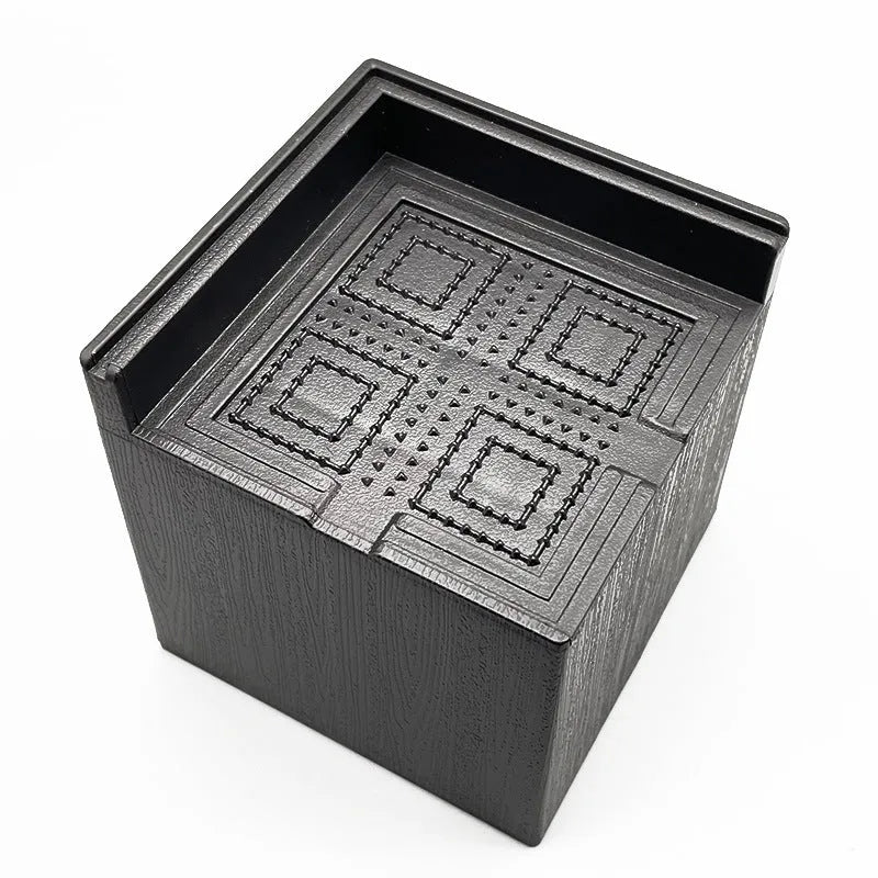 Four black plastic bed foot mats for furniture height adjustment and leg stabilisation