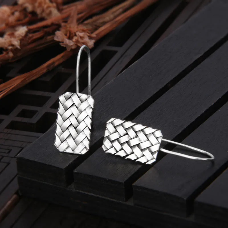 Sterling silver rectangular drop earrings with a woven diamond plaid geometric pattern.