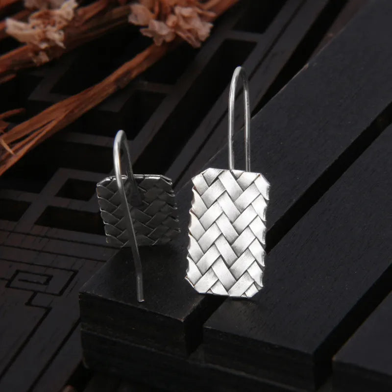Sterling silver rectangular drop earrings with a woven diamond plaid geometric pattern.
