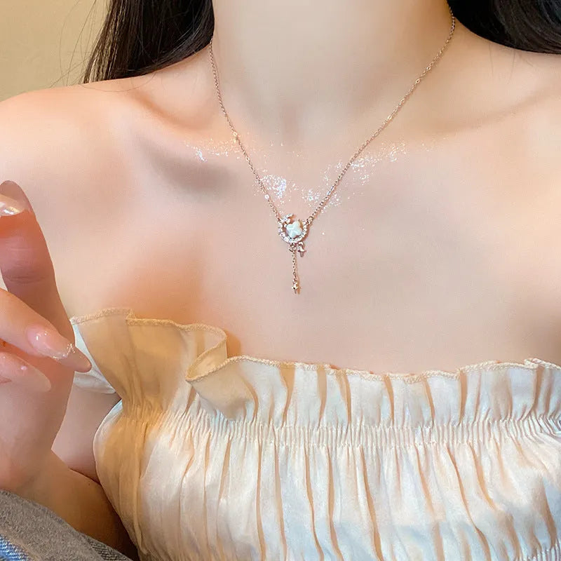 Gold-tone star and moon pendant necklace on an adjustable copper chain.
