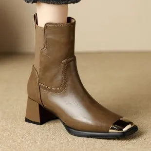 Brown leather women's Martin boots with a high heel and side zipper on a white background.