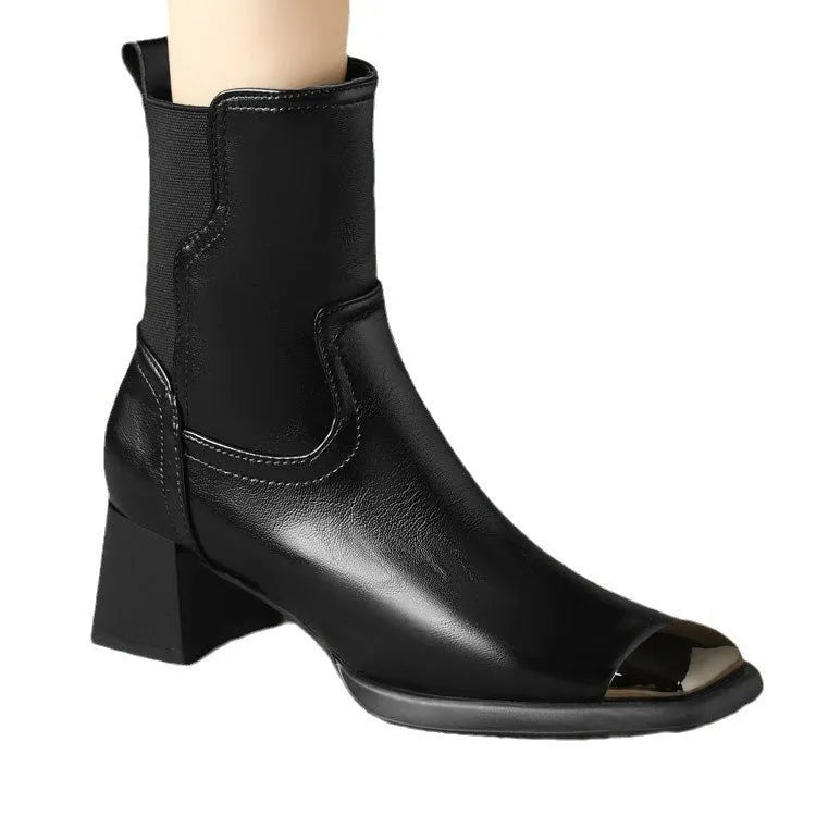 Brown leather women's Martin boots with a high heel and side zipper on a white background.