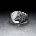 Silver geometric wolf-shaped alloy ring for men on a plain background.