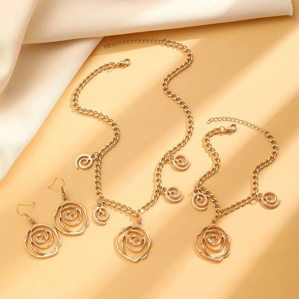 Spiral donut geometric jewellery set with necklace, bracelet, and ear hooks in gold or silver electroplated finish