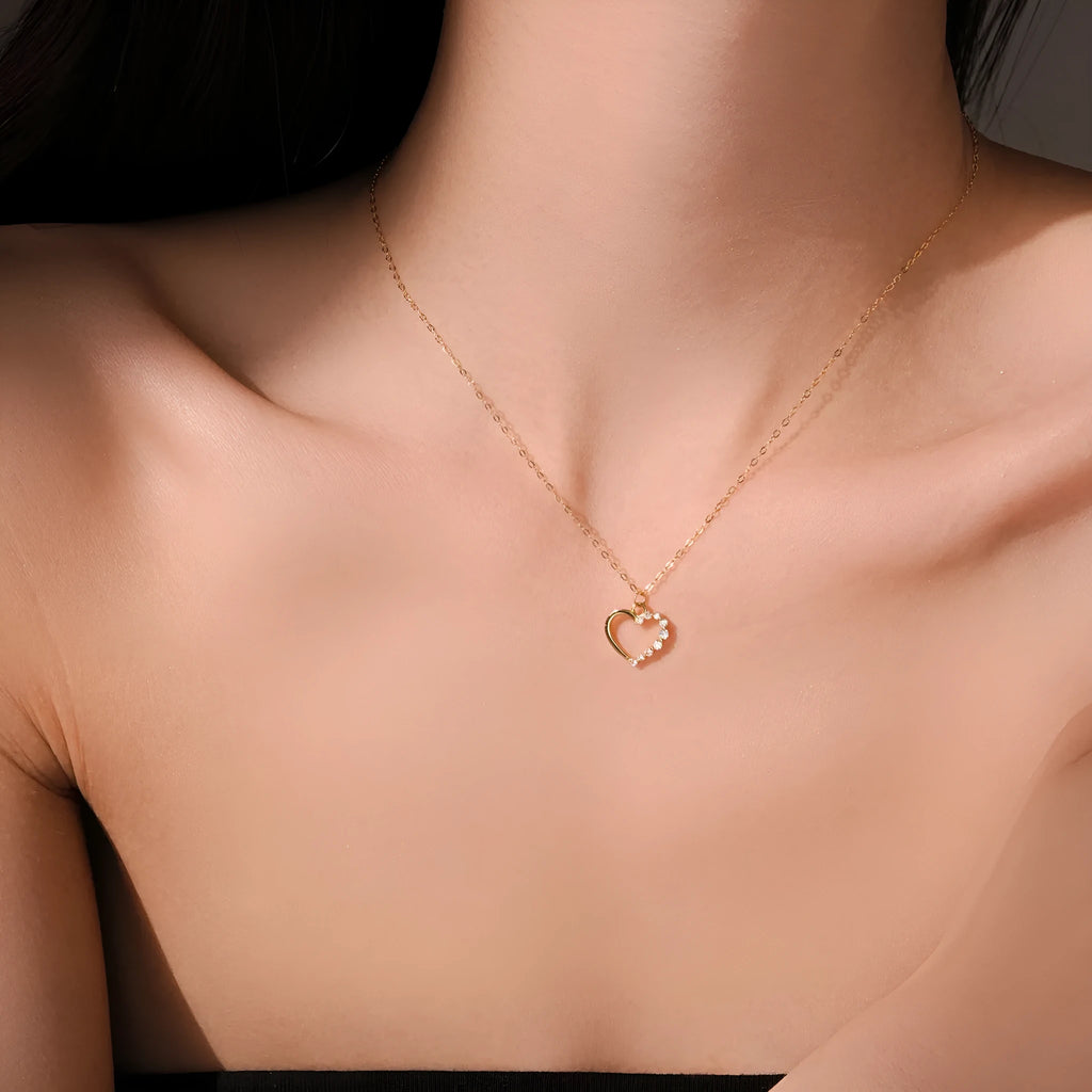 Sterling silver hollow heart pendant necklace on a regular chain, available in white gold or platinum plating.