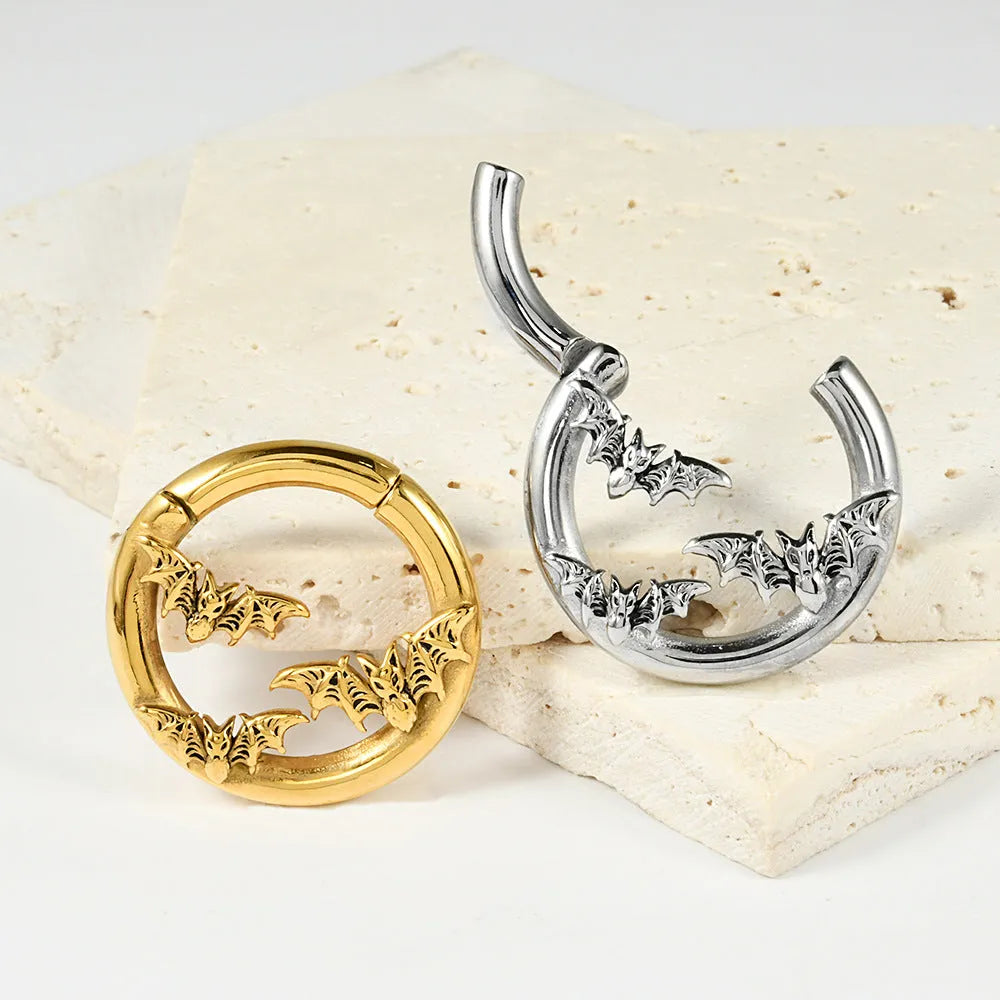 A pair of stainless steel fashion earrings featuring a shaped totem pattern in an electroplated finish.