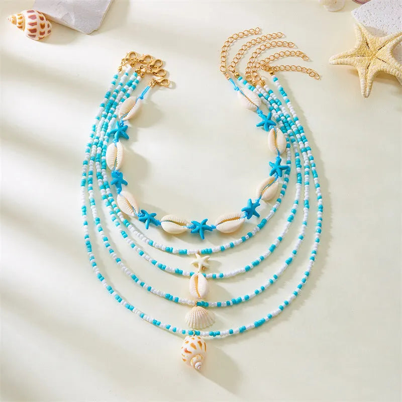 Five multi-layer women's necklaces with starfish shell conch bead designs in blue and mixed colours