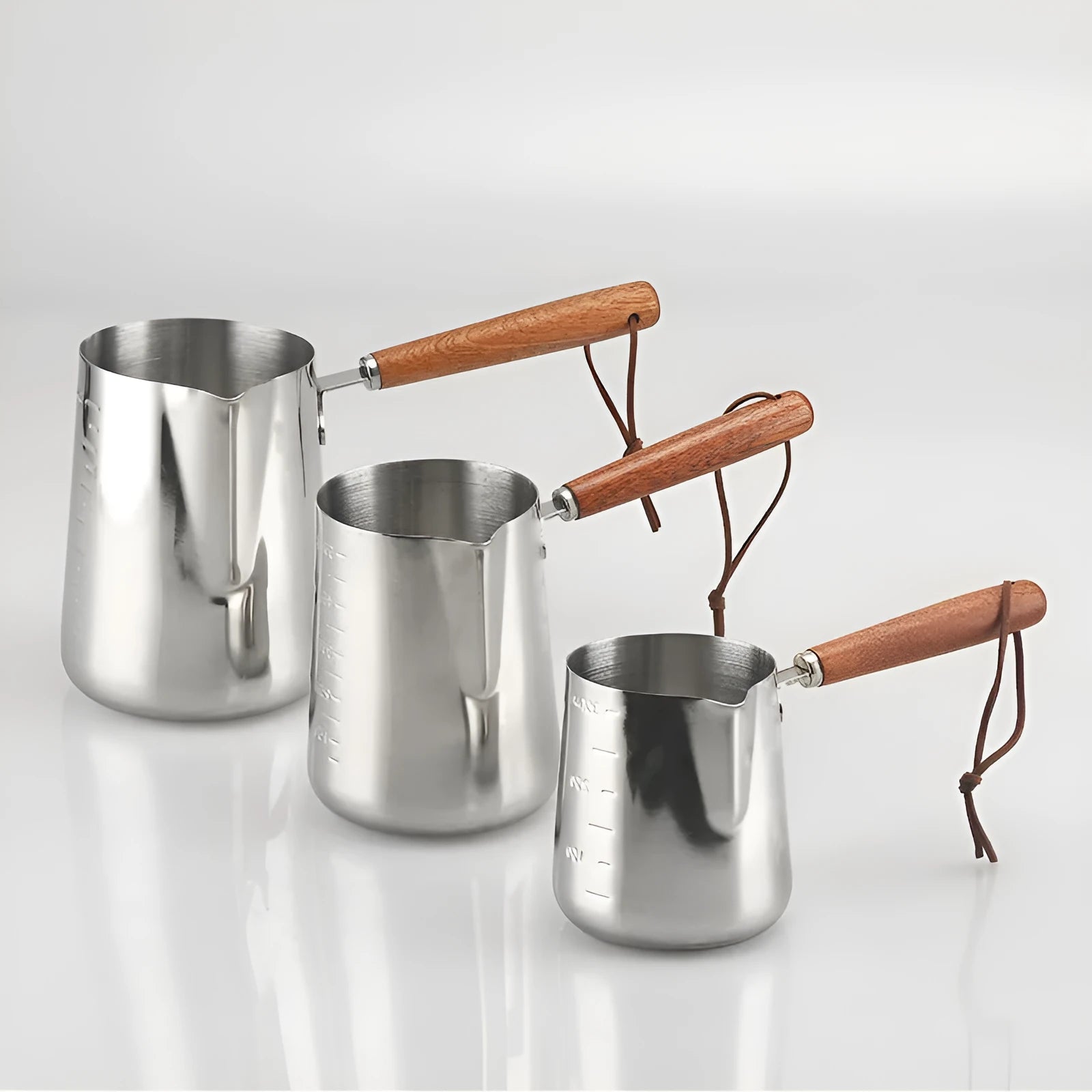 Stainless steel garland coffee cup with a scaled wooden handle shown in a simple solid colour.
