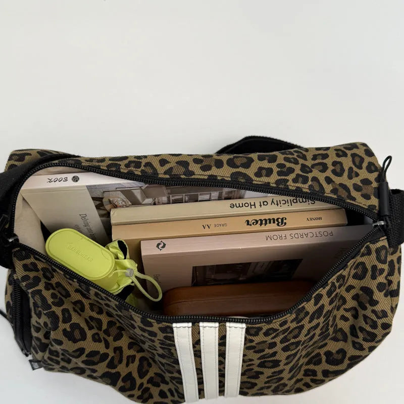 Leopard print crossbody messenger bag with stitching details and shoulder strap