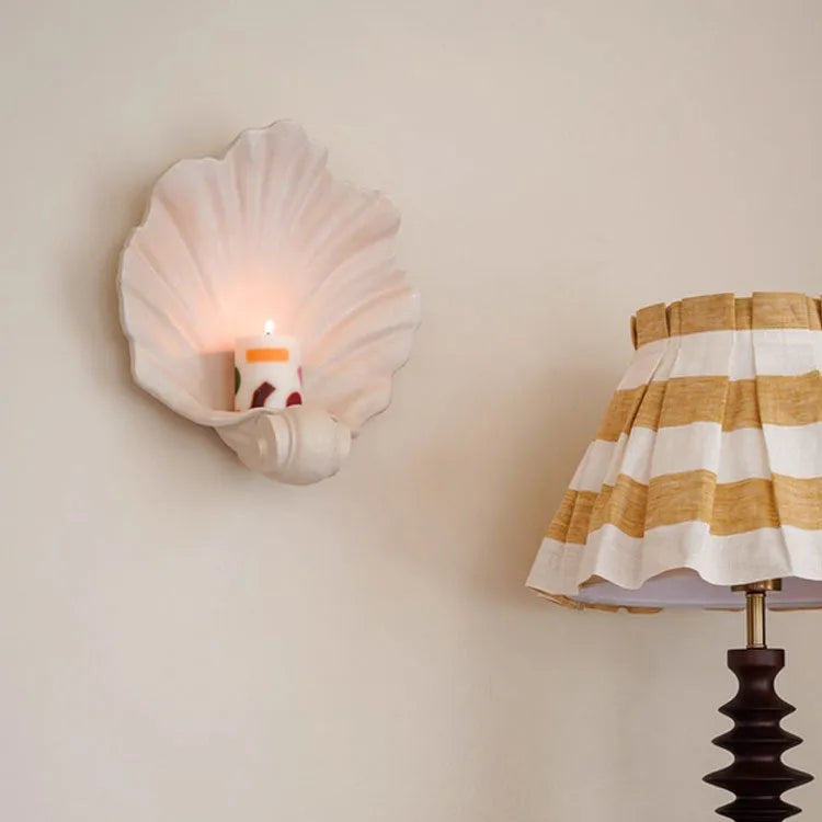White resin shell-shaped fruit plate ornament with light luxury styling on a table.