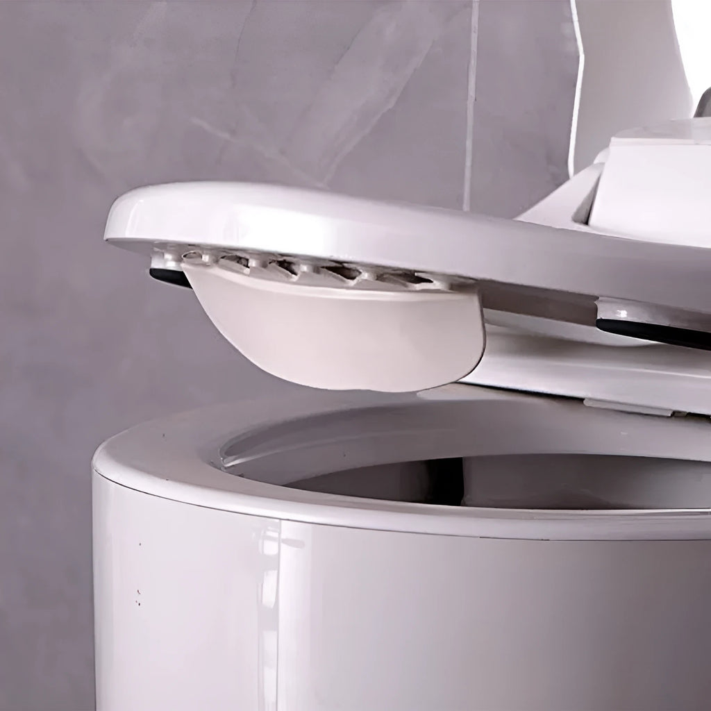 White PVC toilet training splash guard placed on a toilet seat.