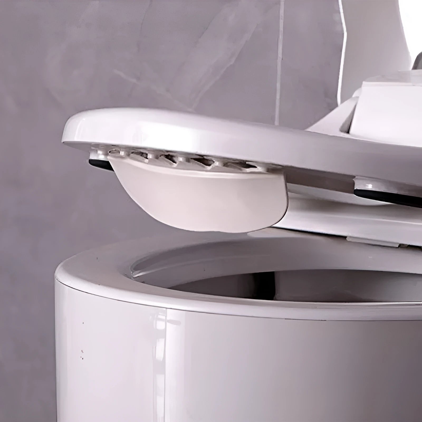 White PVC toilet training splash guard placed on a toilet seat.