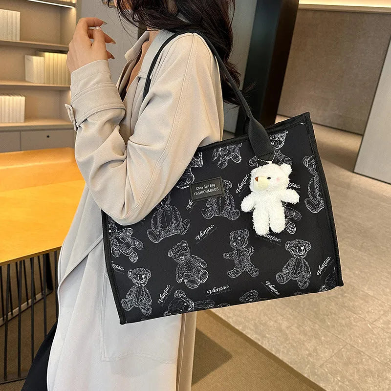 Women's black canvas tote bag with rhombus pattern and shoulder strap