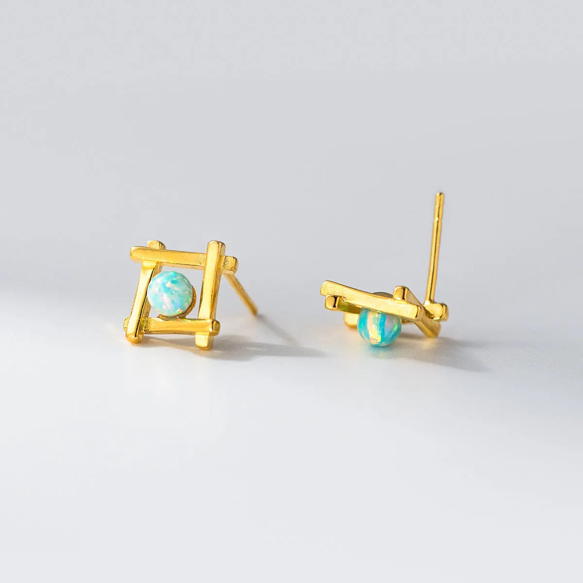 Geometric cross quadrangle sterling silver 925 stud earrings for women in gold and silver finishes.