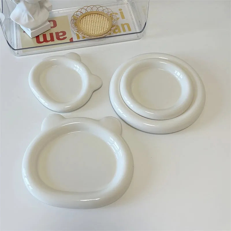 White porcelain plate with cute bear doodle design, 20cm size, on a table.