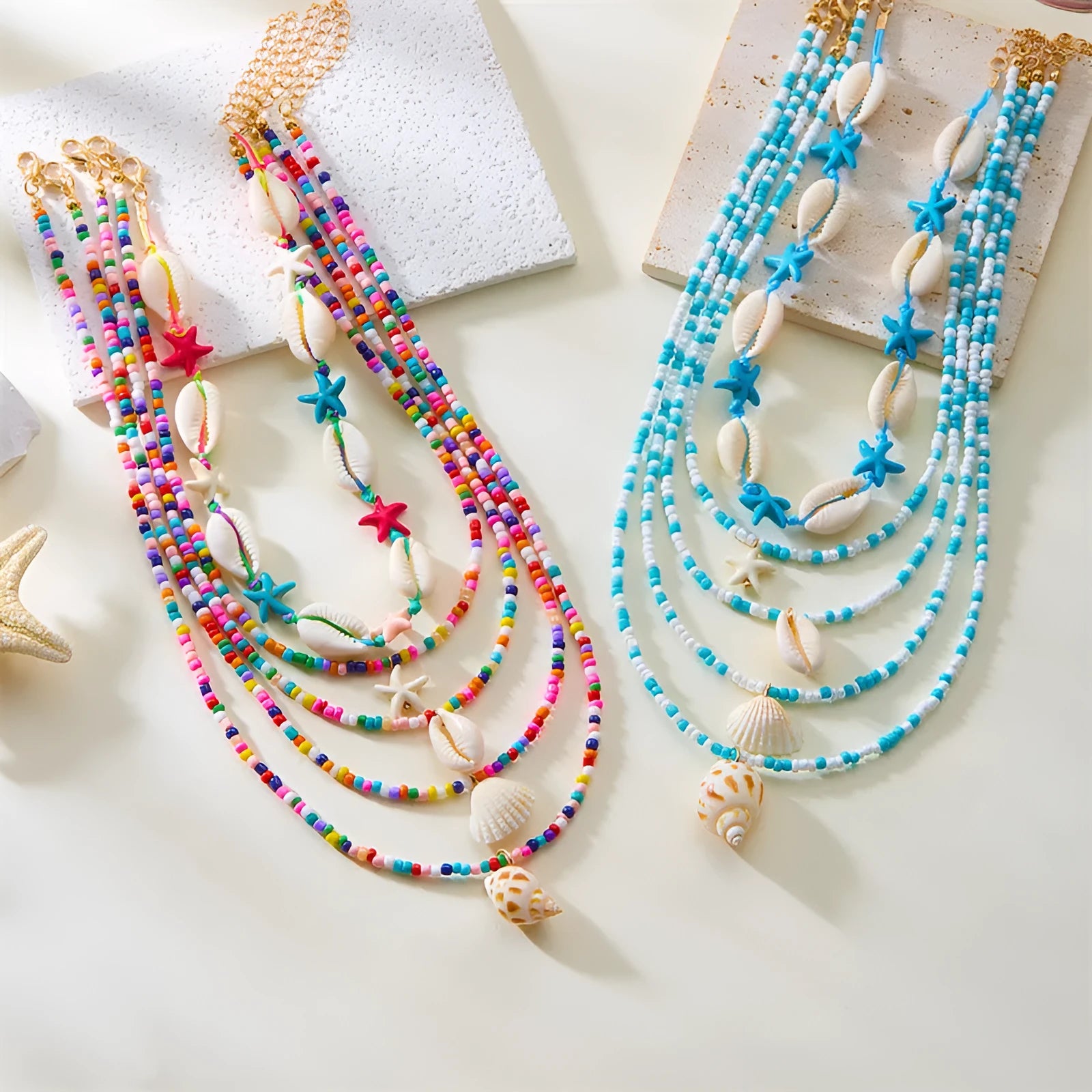 Five multi-layer women's necklaces with starfish shell conch bead designs in blue and mixed colours