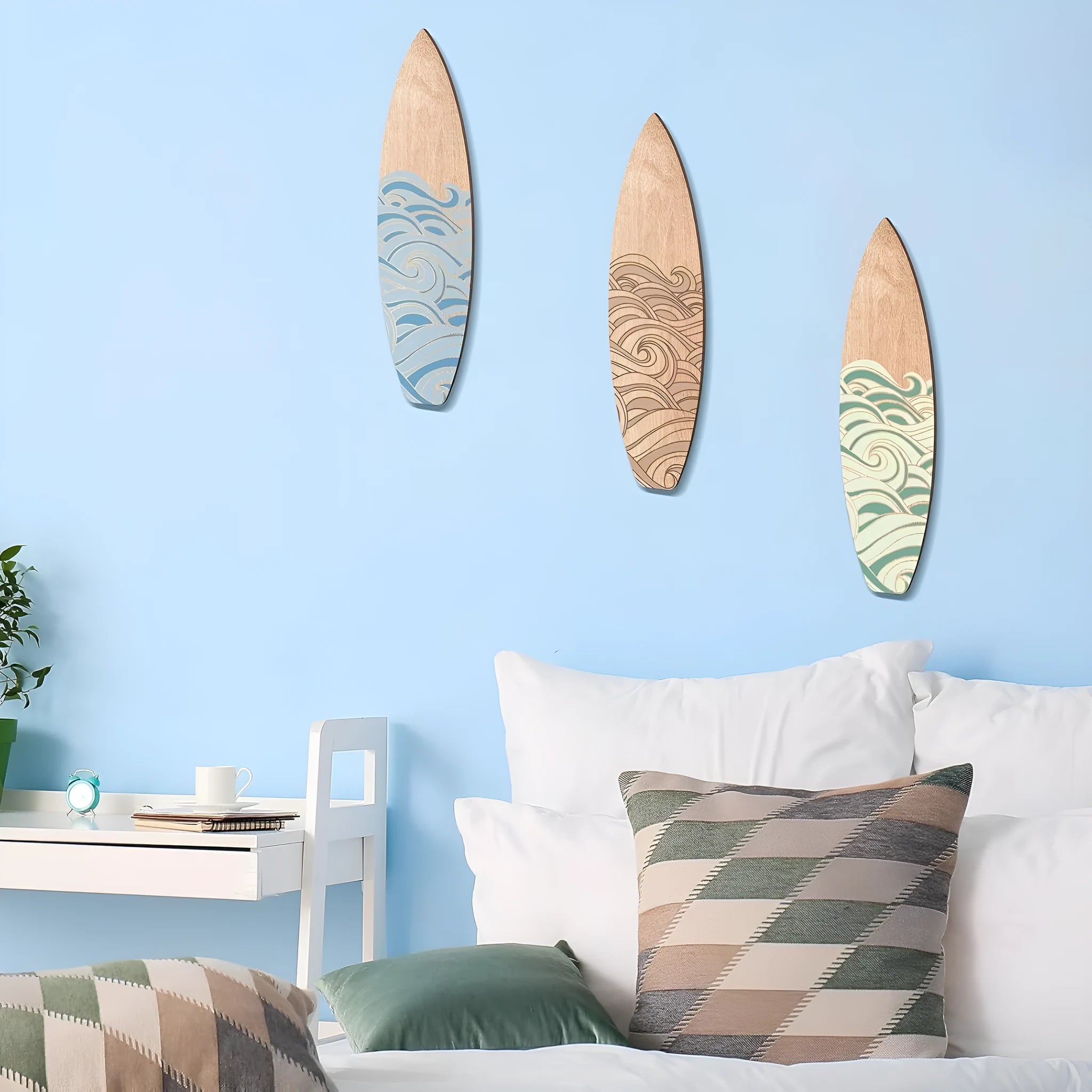 Three wooden surfboard wall decorations with European coastal design carved from boxwood