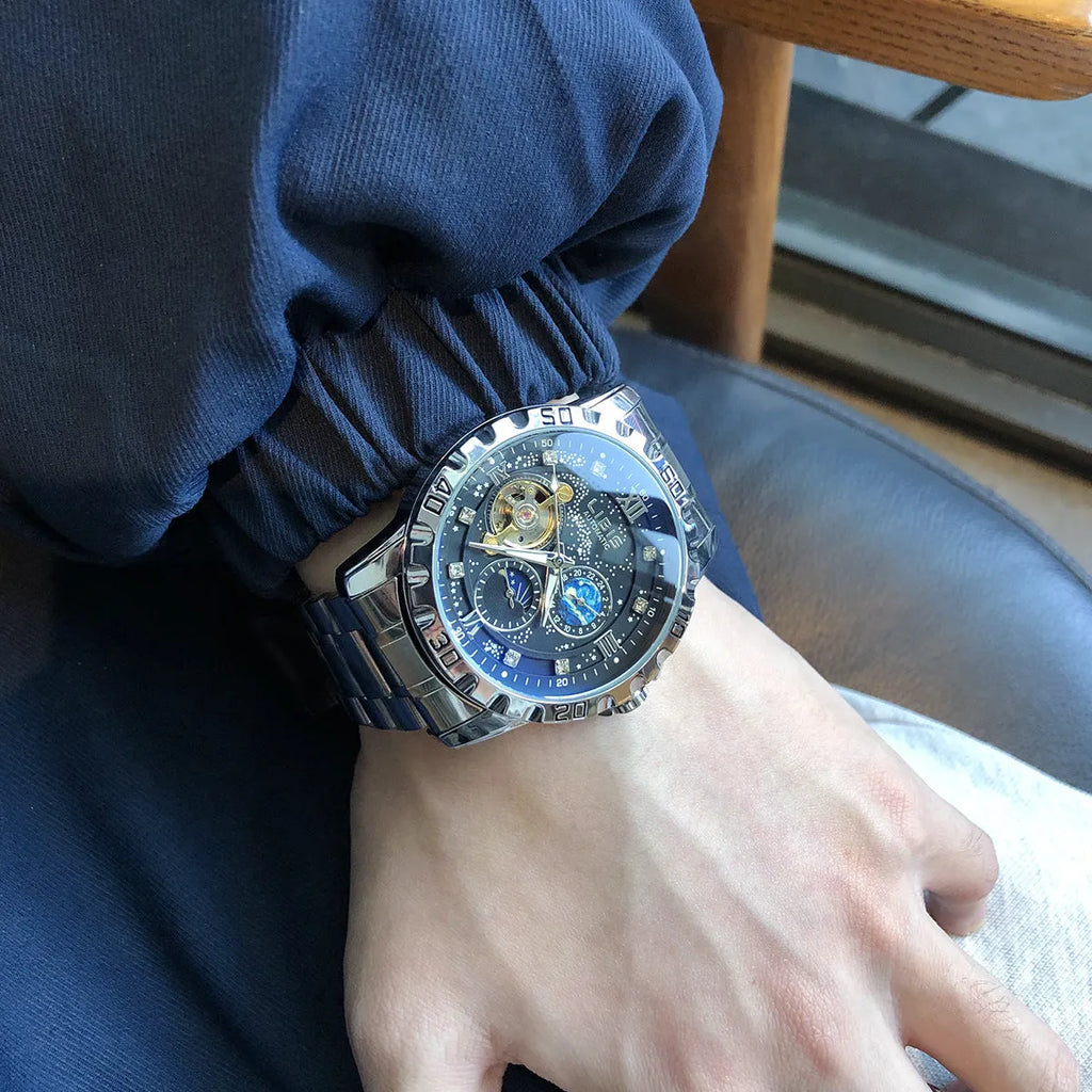 Silver case men's automatic watch with black starry dial, luminous markers, and leather strap