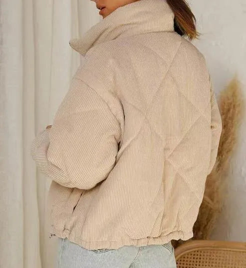Apricot-coloured women's corduroy jacket with a stand collar and front zip, shown on a hanger.