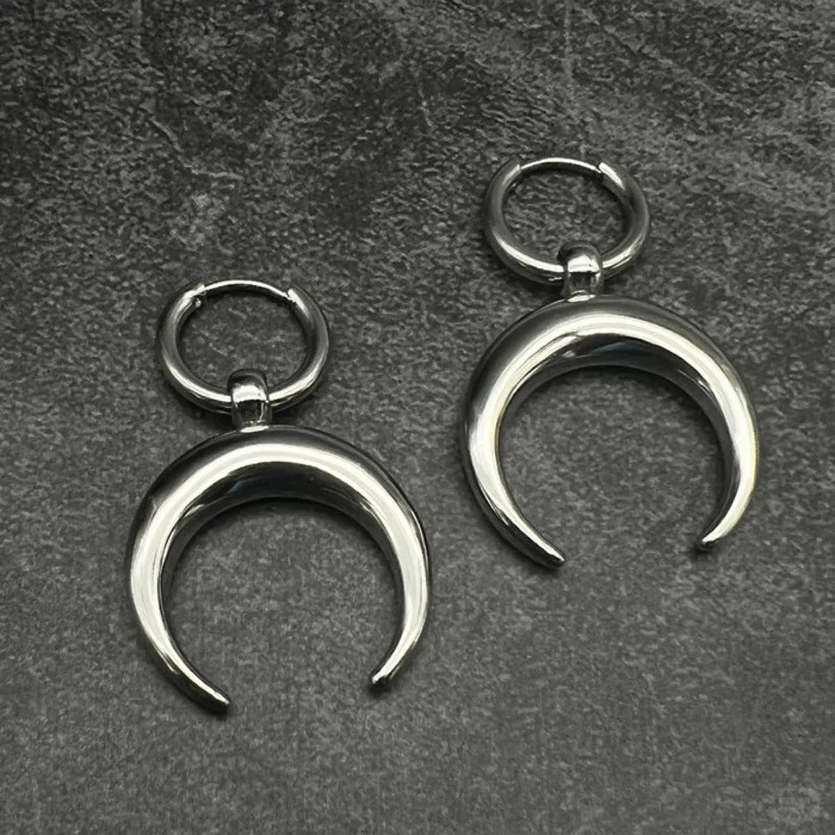 Silver geometric hoop earrings with moon detail and clip fastening