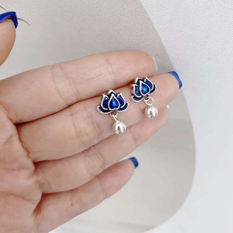 A pair of alloy lotus ear studs with retro seedpod tassel design, shown in lotus colour.