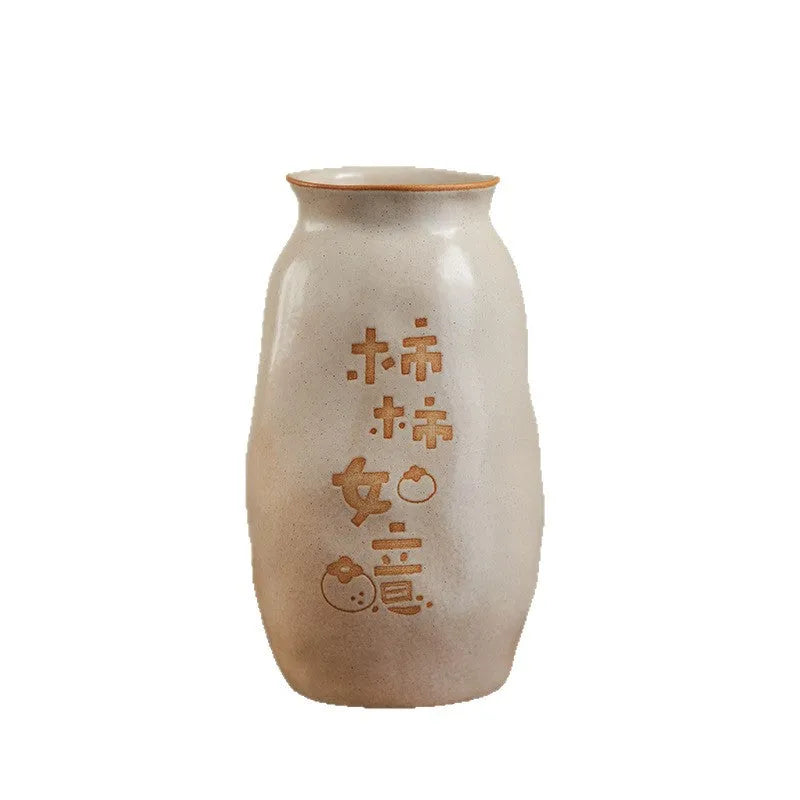 Chinese hand-painted ceramic joy vase with carved decorations on wooden desktop