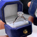 White gold plated geometric ring with six-claw setting holding a zircon stone.